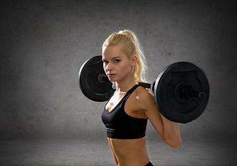 Image showing sporty woman exercising with barbell
