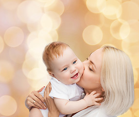 Image showing happy mother kissing smiling baby