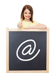 Image showing smiling girl with blackboard showing thumbs up