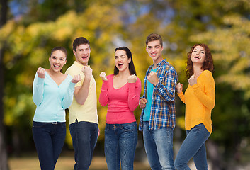 Image showing group of smiling teenagers over green park