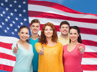 Image showing group of smiling teenagers over american flag