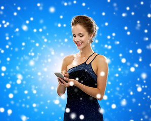 Image showing smiling woman in evening dress with smartphone