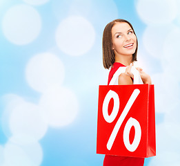 Image showing woman in red dress with shopping bags