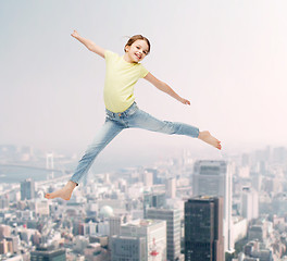 Image showing smiling little girl jumping