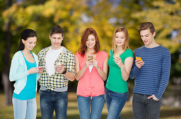 Image showing smiling students with smartphones