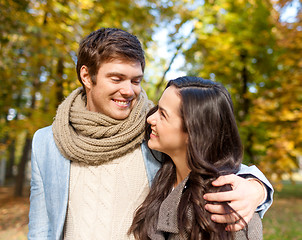 Image showing smiling couple hugging in autumn park