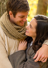 Image showing smiling couple hugging in autumn park