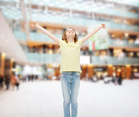 Image showing smiling teenage girl with raised hands