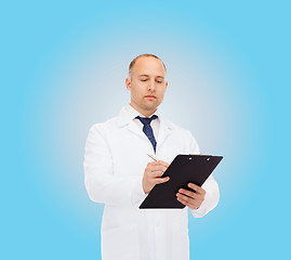 Image showing serious male doctor with clipboard