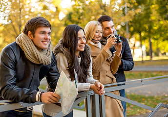 Image showing group of friends with map and camera outdoors