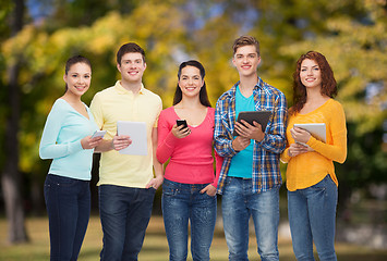 Image showing group of teenagers with smartphones and tablet pc