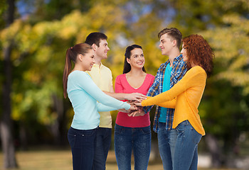 Image showing group of smiling teenagers over green park