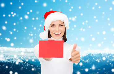 Image showing woman in santa helper hat with blank red card