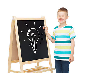 Image showing smiling little boy with blank blackboard