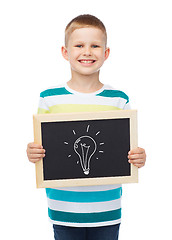 Image showing smiling little boy with blank blackboard