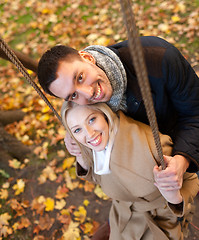 Image showing smiling couple hugging in autumn park