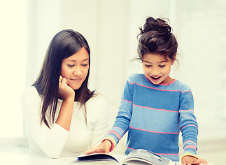 Image showing mother and daughter with book