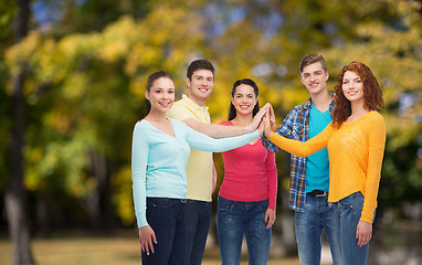 Image showing group of smiling teenagers over green park