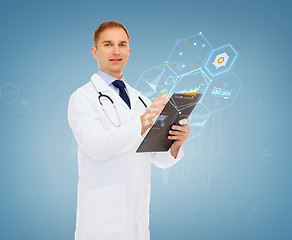 Image showing smiling male doctor with clipboard and stethoscope