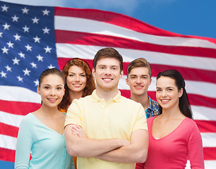 Image showing group of smiling teenagers over american flag