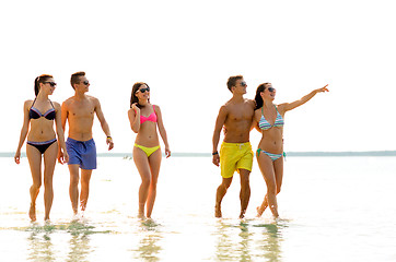 Image showing smiling friends in sunglasses on summer beach