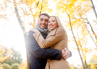 Image showing smiling couple hugging in autumn park