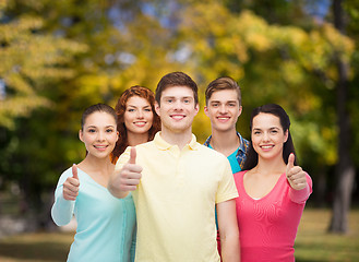 Image showing group of smiling teenagers over green park