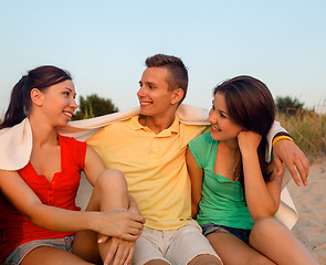 Image showing smiling friends in sunglasses on summer beach