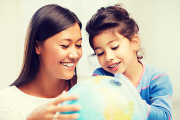 Image showing mother and daughter with globe