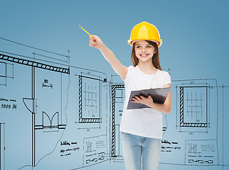 Image showing smiling little girl in hardhat with clipboard