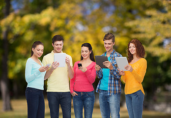 Image showing group of teenagers with smartphones and tablet pc