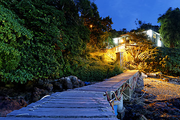 Image showing boat pier and small house at night