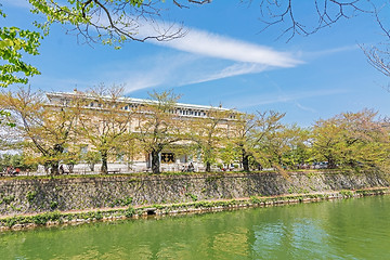 Image showing Emerald green cherry trees and Kyoto Municipal Museum