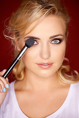 Image showing Beautiful blond woman applying eye makeup