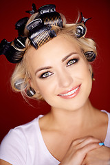 Image showing Beautiful blond with her hair in curlers