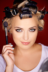 Image showing Beauty portrait of a blond wearing curlers