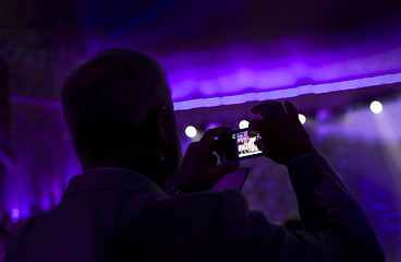 Image showing Man taking pictures during a concert