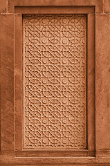 Image showing Decorative stone panel on the wall on facade of the building. In