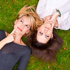 Image showing Two girls lying in the grass