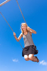 Image showing Woman swinnging on a swing.
