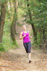 Image showing Pretty young girl runner in the forest. 