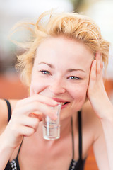 Image showing Lady having a shot of spirit drink.