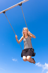 Image showing Woman swinnging on a swing.