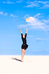 Image showing Playful girl throwing sand in the air.
