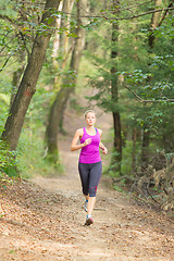 Image showing Pretty young girl runner in the forest. 