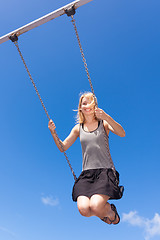 Image showing Woman swinnging on a swing.