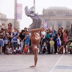 Image showing Street performer breakdancing in front of the random crowd.