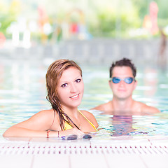 Image showing Young couple in the swimming pool.