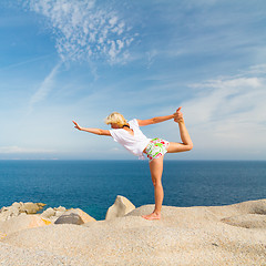 Image showing Woman practicing yoga at the beach.