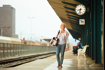 Image showing Lady waiting at the railway station.